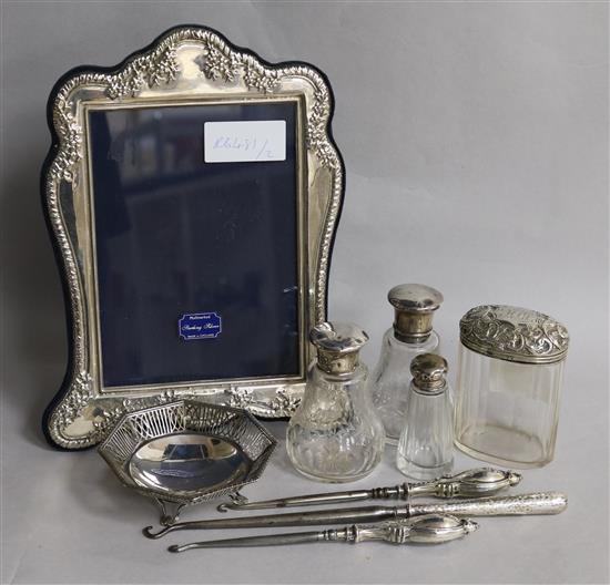 Mixed silver including a photograph frame, toilet jars and a bonbon dish.